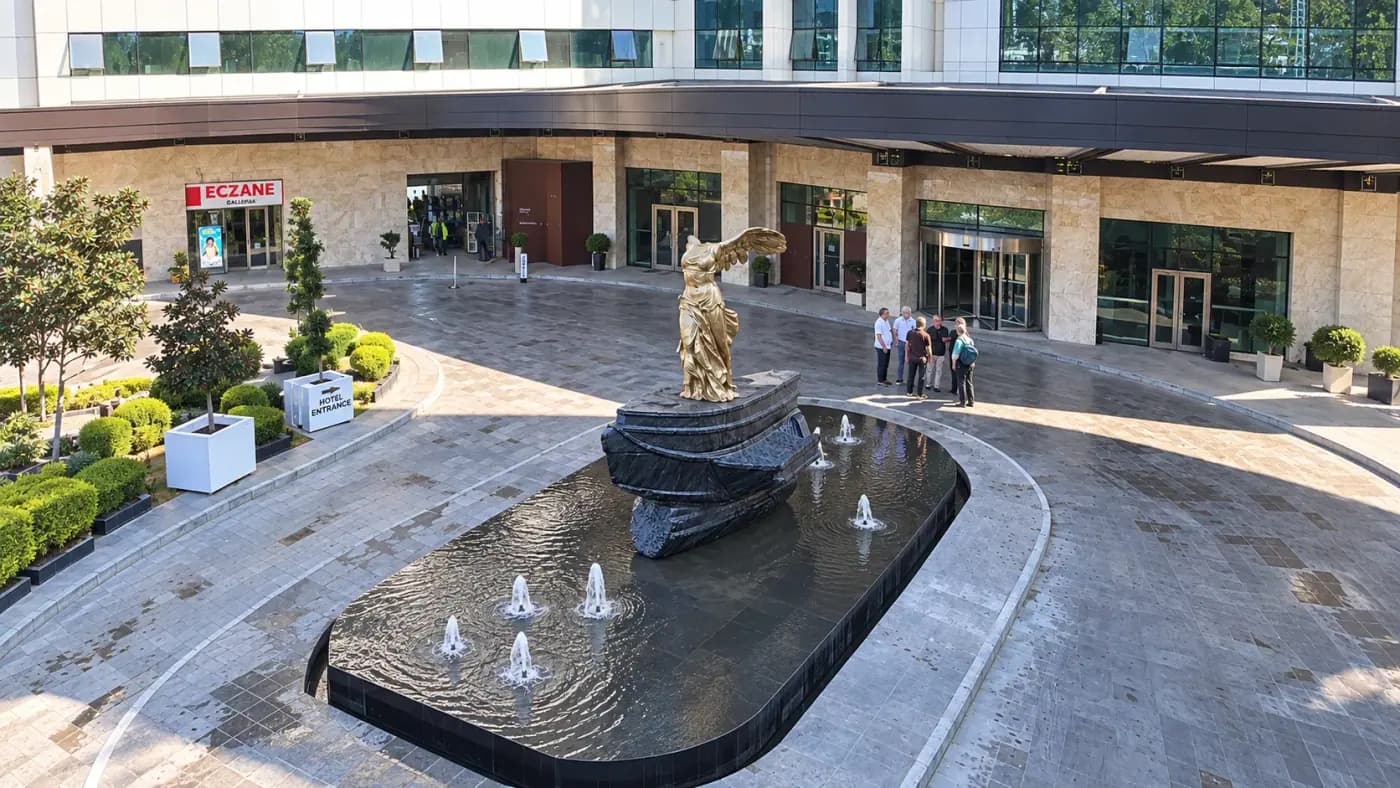 The finished work in the plaza where it was installed, standing in its pool